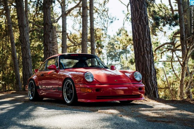 A 1989 Porsche 964 sits in a treeline near 911 Design in Southern California.
