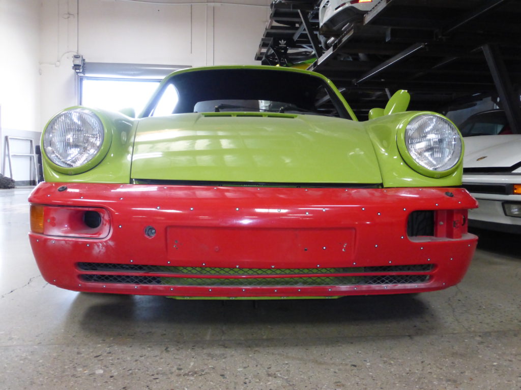 A 1993 Porsche® 964 with a customized front bumper and LED dash headlights.